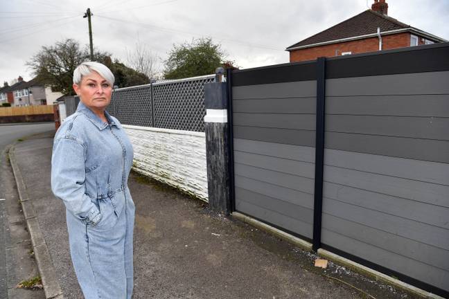 Lianne and her fence, the newer half of it on the right needs to come down but the older left half can stay as it's more than four years old. Credit: Media Wales