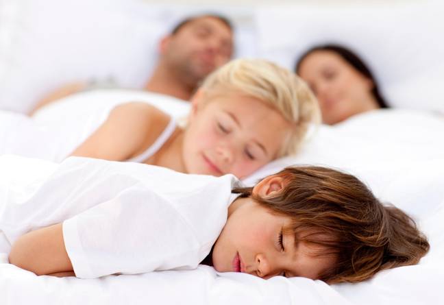 Parents are sharing why they let their children sleep in their bed. Credit: YAY Media AS / Alamy Stock Photo.