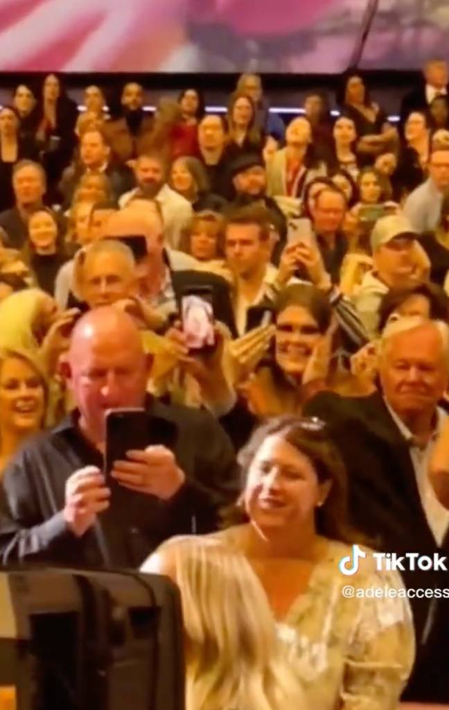 The man appeared to be holding up a photo of his wife. Credit: TikTok/@adeleaccess