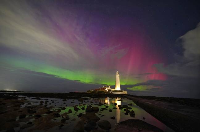 The Northern Lights pictured on the horizon at St Mary's Lighthouse in Whitley Bay on the North East coast. Credit: PA Images / Alamy Stock Photo