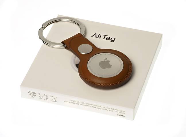 This is the Apple AirTag, a tracking device which unfortunately has been used by thieves and stalkers. Credit: Teodor Costachioiu / Alamy Stock Photo