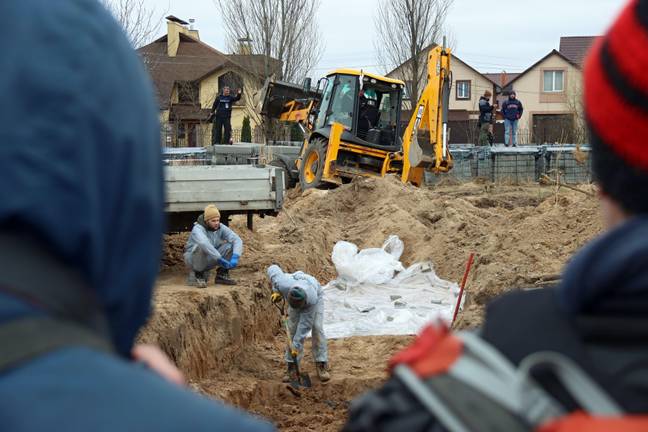 Mass graves being dug in Bucha, Ukraine after 500 bodies were found in the aftermath of the massacre. Credit: Alamy