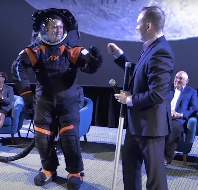 Casually fist-bumping in the new suit. Credit: YouTube/NASA