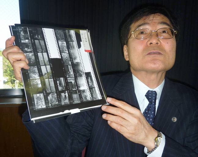 Lawyer Hideyo Ogawa holding an item of evidence related to the 1966 murder of the family of four. Credit: Newscom / Alamy Stock Photo