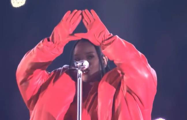 Illuminati confirmed, please ignore that she just sung the words 'diamonds in the sky' right before doing this. Credit: NFL/YouTube