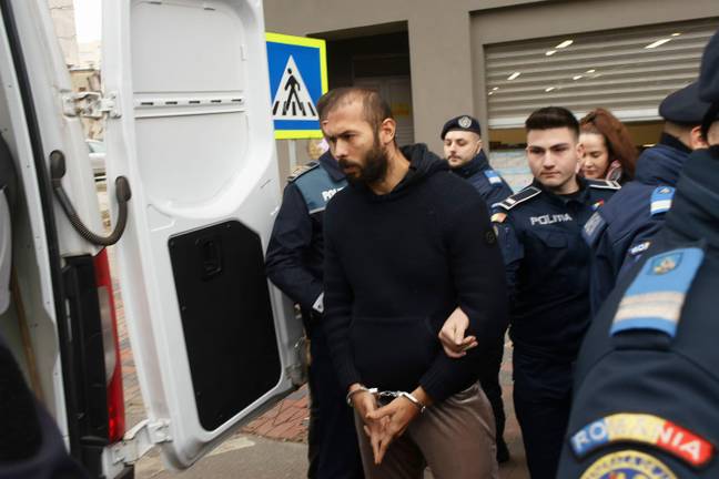 Andrew Tate being taken away by Romanian police. Image: Alamy 