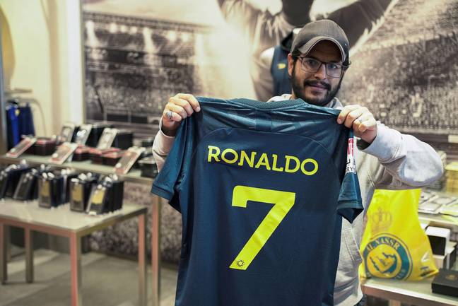 A fan holds up an Al Nassr shirt with Cristiano Ronaldo's name on the back. Image credit: Alamy