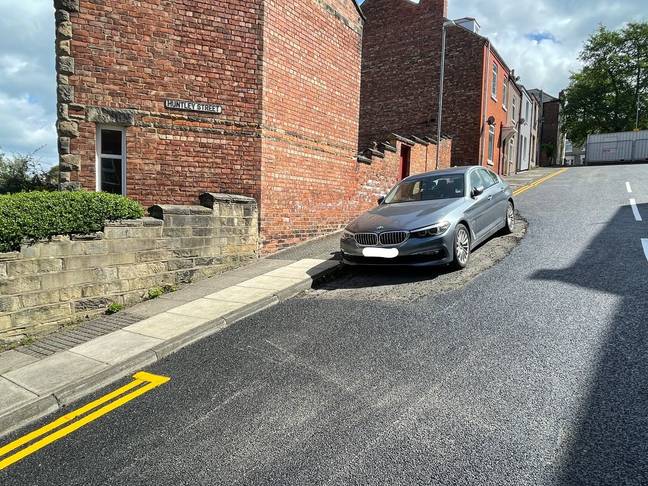 Road workers had no choice but to tarmac around the stationary BMW. Credit: Evening Gazette