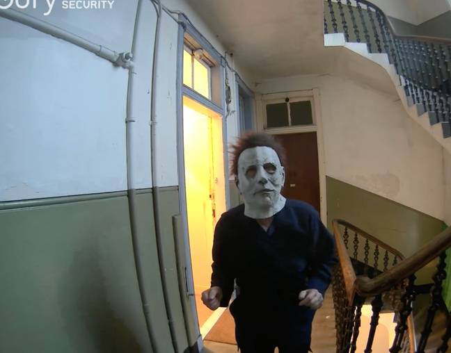 The woman captured terrifying footage of her neighbour shuffling around outside her front door wearing a Michael Myers Halloween mask. Credit: Reddit/Shelbym806