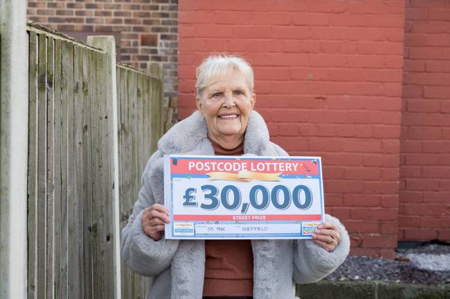 Jan looking thrilled with her Postcode Lottery winnings. Credit: SWNS