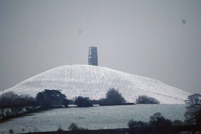 Snow surrounding Glastonbury Tor in Somerset in the early hours of today. Credit: PA
