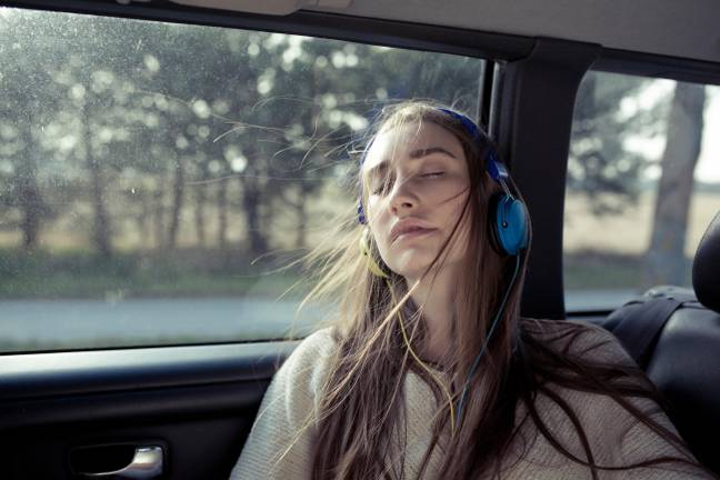 One expert has warned people not to drive while listening. Credit: Westend61 GmbH/Alamy Stock Photo