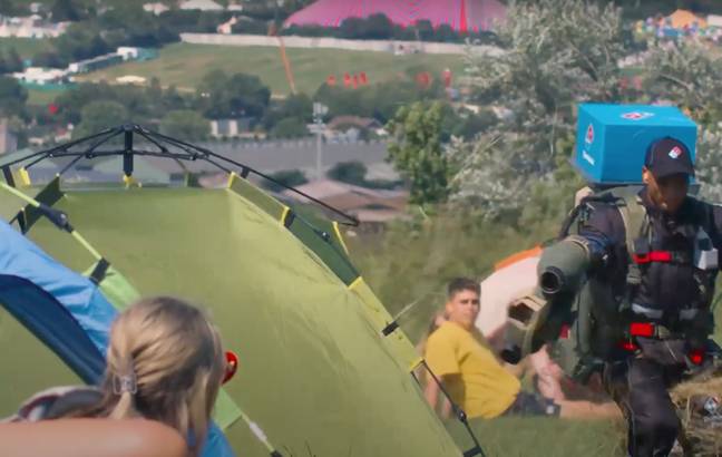 Imaging opening your tent to see a Domino's deliver driver with a jet pack. Credit: YouTube/The Independent