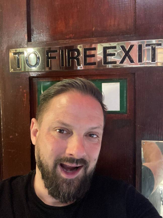 Presumably he's going to be posing next to fire exit signs for the rest of his days. Credit: Jam Press