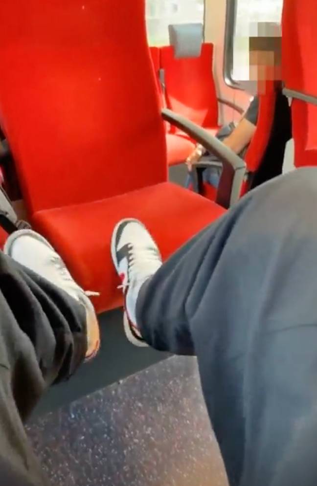 A TikTok of a man putting his feet on a train seat has sparked a major debate. Credit: TikTok/@strajca