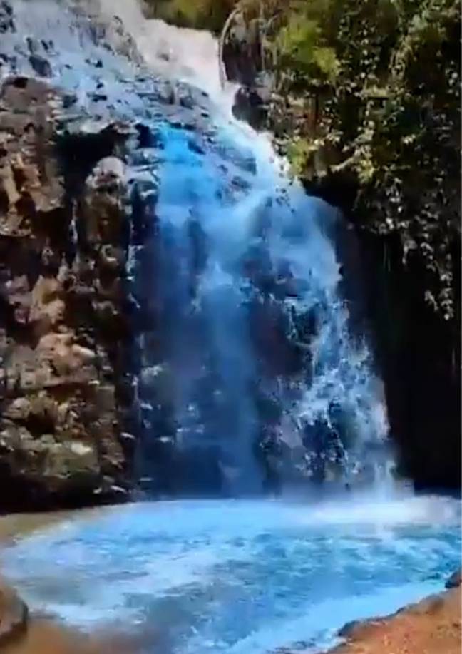 The natural waterfall was dyed blue for the occasion. Credit: CEN