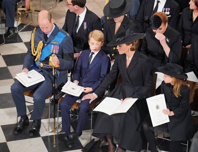 Kate comforts George during the service. Credit: PA/Dominic Lipinski.