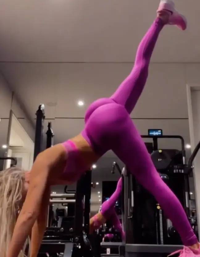 As she stretches her leg up, fans alleged they could see her 'butt implants'. Credit: Instagram/@khloekardashian
