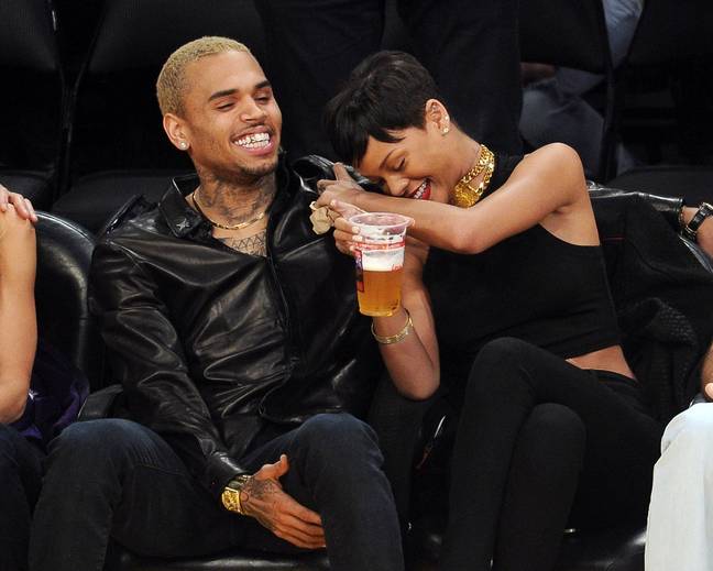 Rihanna was famously pictured laughing alongside ex-boyfriend Chris Brown at a LA Lakers game in 2012. Credit: Headlinephoto Limited / Alamy Stock Photo