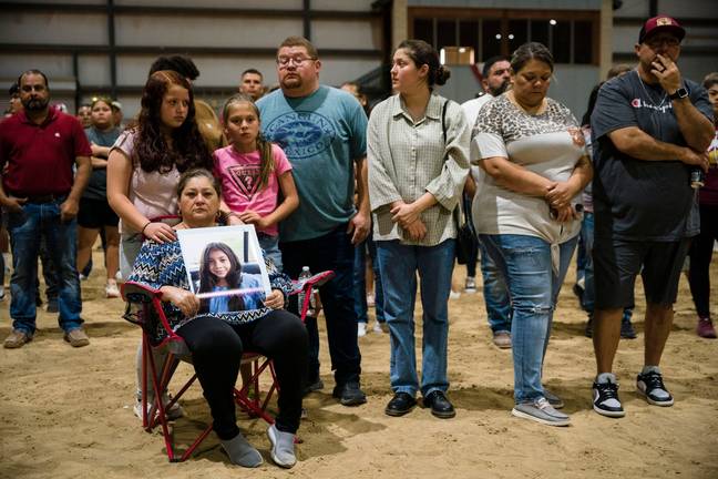 The family of Nevaeh Bravo hold a photo of her at a vigil for the Robb Elementary School shooting victims. (Credit: Alamy)