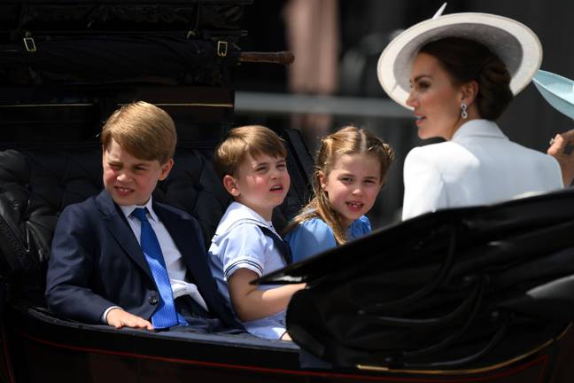 The siblings sat next to each other beside their older brother Prince George, eight, across from their mother Kate. Credit: Alamy.