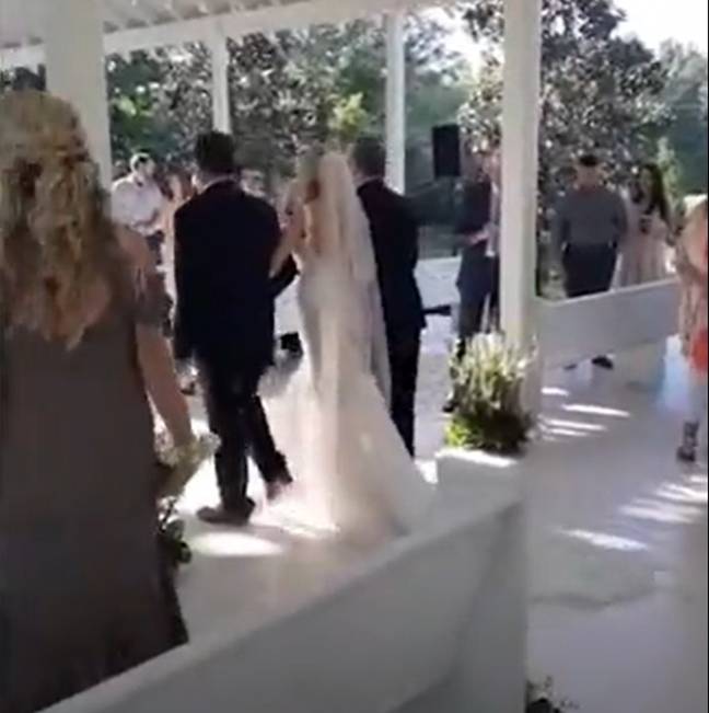 Both men walked the bride down the aisle at her wedding. Credit: TikTok/@_kelseygriffith_