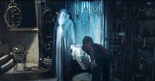 To view memories through the pensieve, Harry dunks his head straight into the basin. (Credit: Warner Bros.)