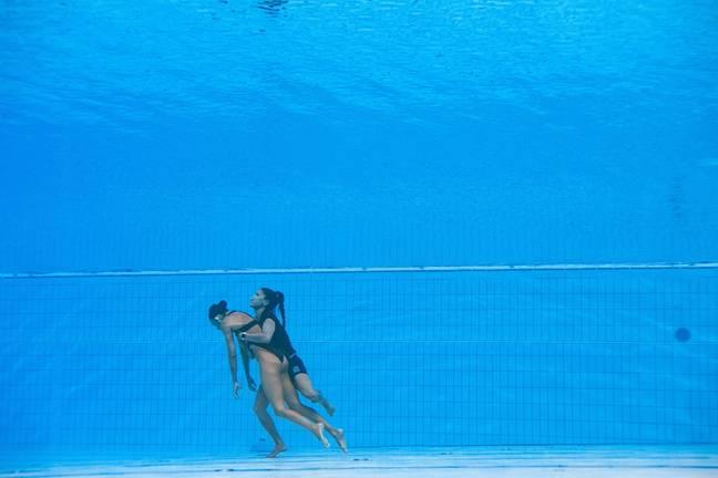 The coach jumped into the pool and swam downwards to reach the unconscious swimmer. Credit: Getty Images