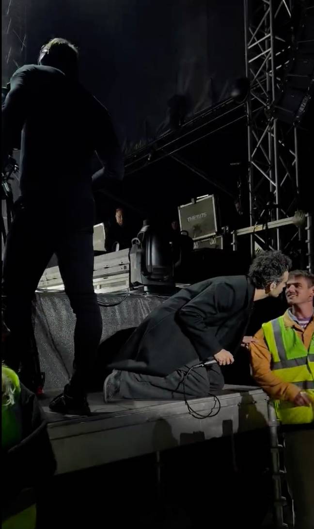 Matty Healy shared an intimate moment with a security guard. Credit: Twitter/@EmChrisL/PA Wire