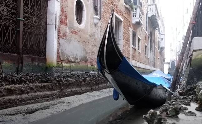 The city is strewn with boats at the bottom of muddy channels. Credit: YouTube/The Guardian