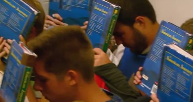 Part of school shooter drills involve students hiding in the corner with books over their faces. Credit: YouTube/NBC News
