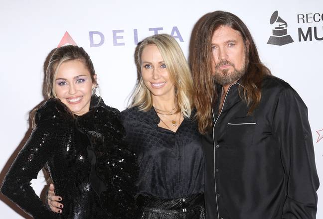 Miley Cyrus pictured with her parents, Tish and Billy Ray Cyrus. Credits: Michael Tran/FilmMagic