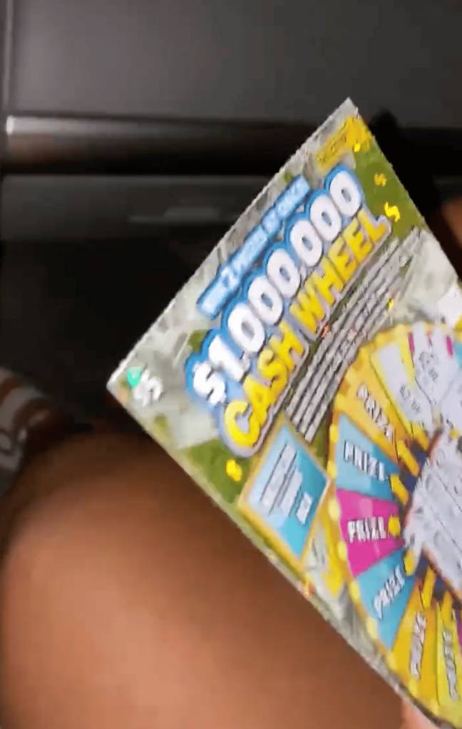 She shows off the winning scratchcard in the video. Credit: X / ODDSbible