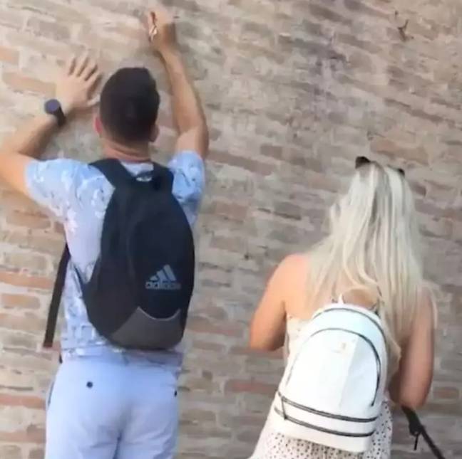 The man was seen defacing the Colosseum. Credit: YouTube/@rytz5873