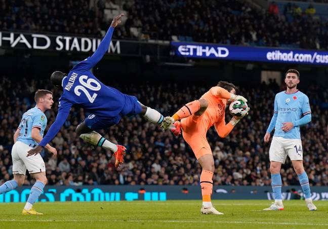 Stefan Ortega of Manchester City collects as Kalidou Koulibaly of Chelsea charges in during the Carabao Cup match. (Alamy)