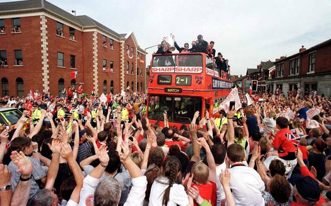 Fans in Manchester enjoy the victory parade in 1999. Image: Alamy
