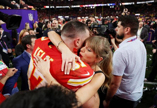Taylor Swift and Travis Kelce embrace after Super Bowl 58. Image: Getty.