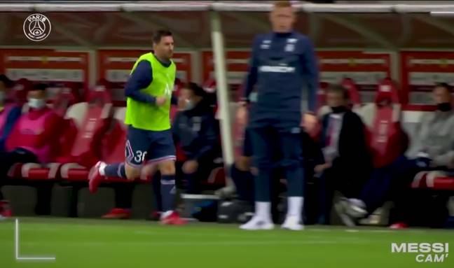 Lionel Messi jogs past Reims interim manager William Still on the touchline. Image credit:  PSG - Paris Saint-Germain/YouTube