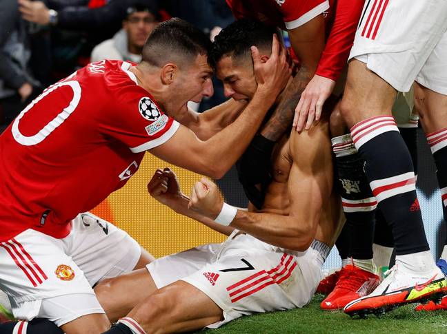 Diogo Dalot celebrates with a shirtless Cristiano Ronaldo after a late winner against Villarreal in the Champions League. (Alamy)