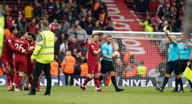 Andy Robertson receives a yellow card. Image: Alamy 
