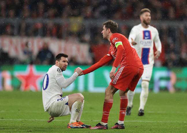 Thomas Muller helps Lionel Messi back to his feet during a Champions League match. Image: Getty