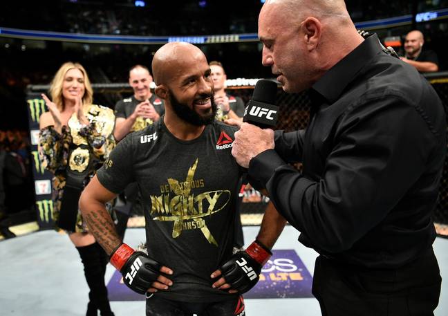 Joe Rogan speaks to Demetrious Johnson after a successful UFC title defence. Image: Getty