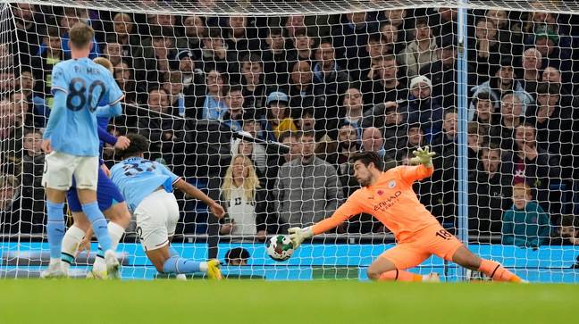 Stefan Ortega of Manchester City makes a save form Lewis Hall of Chelsea (hidden) during the Carabao Cup match. (Alamy)