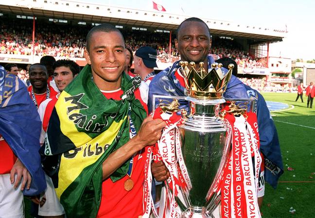 Sila with midfield partner Patrick Vieira and the last Premier League trophy won by Arsenal. Image: Getty