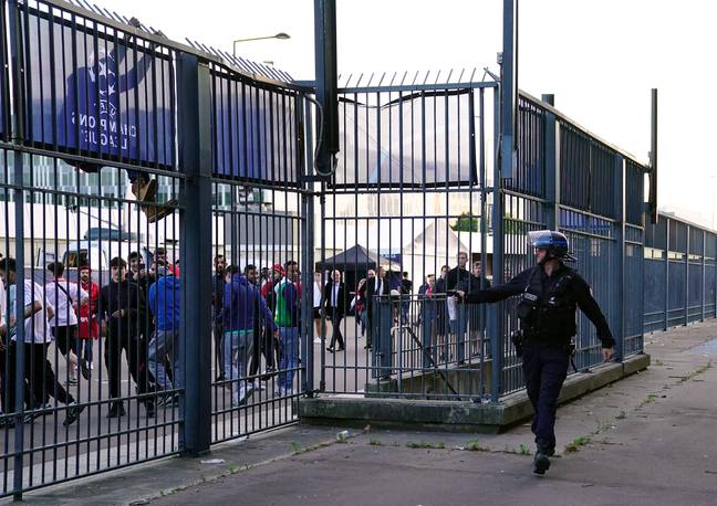 A police officer using pepper spray outside the stadium. (Image Credit: Alamy)