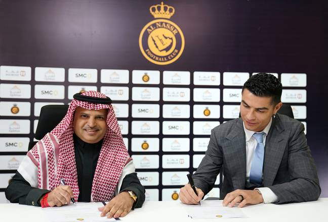 Ronaldo signing his Al Nassr contract. (Image Credit: Alamy)