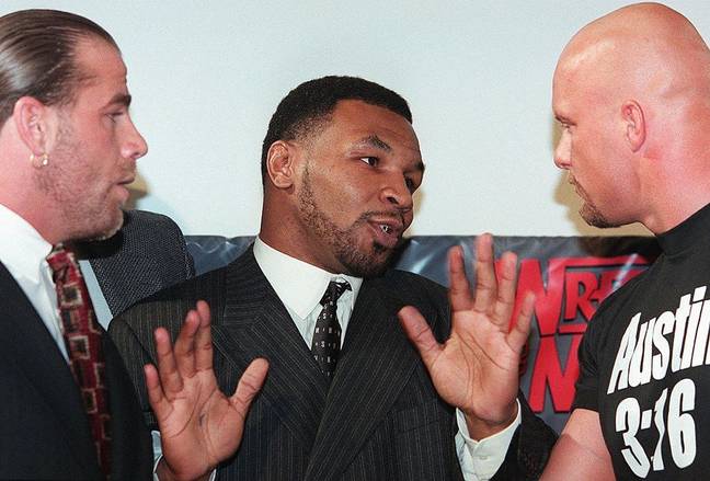 Mike Tyson pictured with Shawn Michaels (left) and 'Stone Cold' Steve Austin (right) before WrestleMania 14 (Credit: Getty)