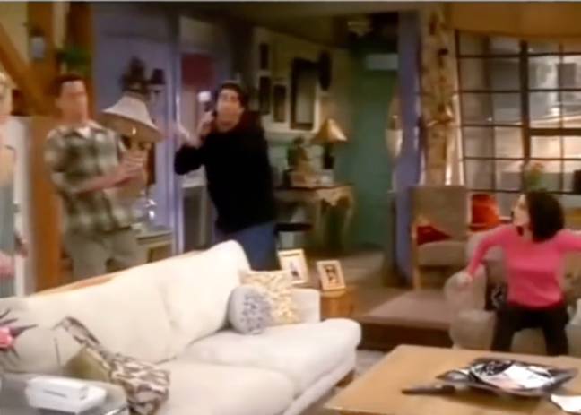 Ross frantically hands Chandler the lamp. Credit: NBC