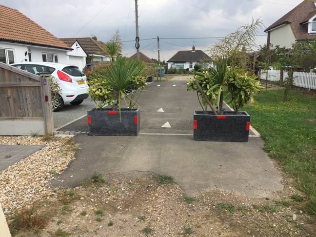 While the speed bumps didn't end up doing the trick, sticking a couple of big planters directly in the road worked. Credit: SWNS