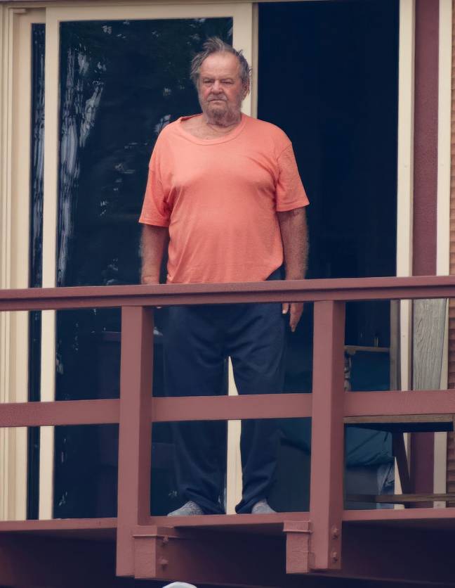 He was spotted looking out from his balcony. Credit: Splash News